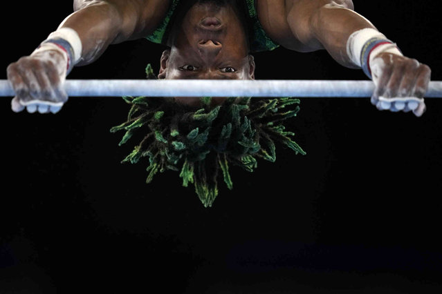 Uche Eke, of Nigeria, competes on the horizontal bar during the men's artistic gymnastic qualifications at the 2020 Summer Olympics, Saturday, July 24, 2021, in Tokyo, Japan. (Photo by Gregory Bull/AP Photo)