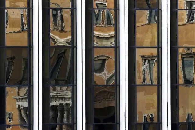 The Greek parliament is reflected on the Foreign Ministry building in Athens March 12, 2015. (Photo by Yannis Behrakis/Reuters)