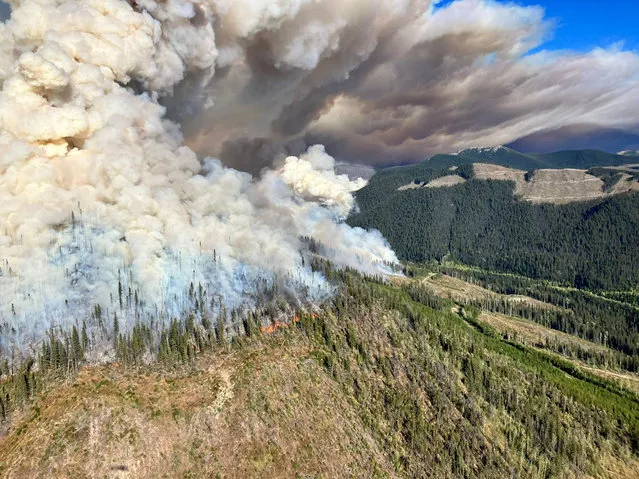 An aerial view shows plumes of smoke rising over burning vegetation during a wildfire in Battleship Mountain, British Columbia, Canada in this handout image released September 10, 2022. (Photo by BC Wildfire Service via Reuters)