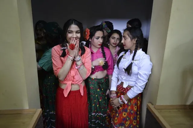 Romanian Roma wait to perform on stage during an International Day of the Roma event in Glina, Romania, Wednesday, April 8, 2015. Romania is home to one of the largest Gypsy, or Roma, communities in Europe, counting more than 600,000 people according to official statistics, actual numbers are likely to be higher since many do not declare their ethnicity in censuses fearing discrimination. (Photo by Andreea Alexandru/AP Photo/Mediafax)