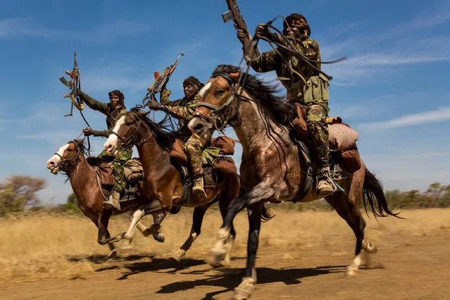 A handout image provided by the World Press Photo (WPP) organization on 18 February 2016 shows a picture by South African photographer Brent Stirton, Getty Images for National Geographic, from a series that won 2nd prize stories in the Nature category of the 59th annual World Press Photo Contest, it was announced by the WPP Foundation in Amsterdam, The Netherlands on 18 February 2016. The picture shows rangers exhibiting their riding skills as they return to Zakouma National Park after weeks on elephant patrol, Zakouma, Chad, 07 January 2015. (Photo by Brent Stirton/World Press Photo Contest/EPA)