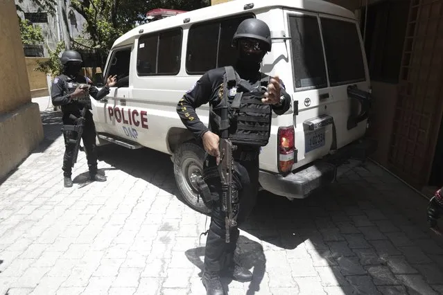 Police stand guard as Colombian suspects arrive in a van to appear before the investigating judge appointed to the case of the assassination of late Haitian President Jovenel Moise in Port-au-Prince, Haiti, Tuesday, August 29, 2023. Moise was assassinated on July 7, 2021, when he was shot a dozen times at his private home in an attack that also seriously injured his wife. (Photo by Odelyn Joseph/AP Photo)