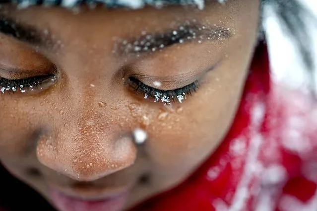 Snowflakes cling to nine-year-old Tamya Hardy's eyelashes as she plays in the snow with friends, in Winston-Salem, N.C., on January 28, 2014. (Photo by Lauren Carroll/Winston-Salem Journal)