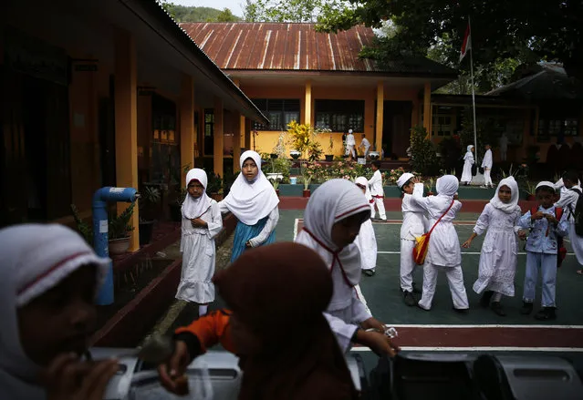 Students gather in front of their classroom on the Maitara island, in Tidore, North Maluku province, Indonesia, March 11, 2016. (Photo by Reuters/Beawiharta)
