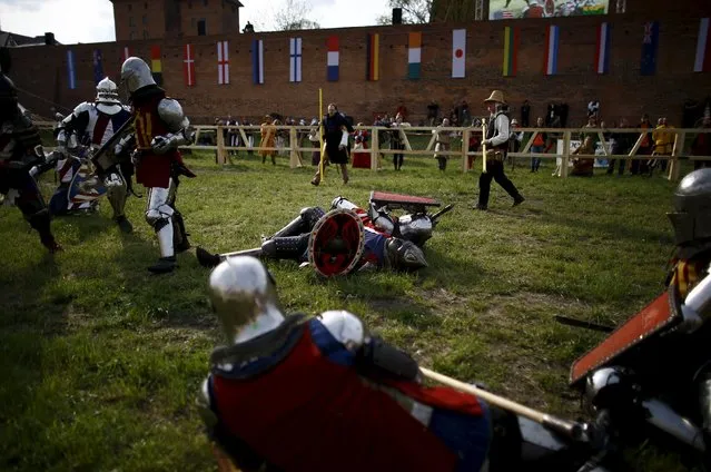 Fighters from U.S. fight compete with their opponents from Lithuania during their “5 vs 5” competition at the Medieval Combat World Championship at Malbork Castle, northern Poland, April 30, 2015. (Photo by Kacper Pempel/Reuters)