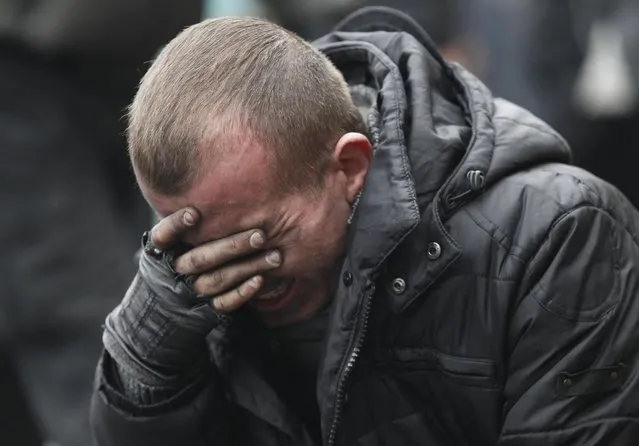 An anti-government protester reacts following clashes with riot police in Independence Square in Kiev February 20, 2014. At least 21 civilians were killed in fresh fighting in Kiev on Thursday, shattering an overnight truce declared by Ukrainian President Viktor Yanukovich, and a presidential statement said dozens of police were also dead or wounded. (Photo by Vasily Fedosenko/Reuters)