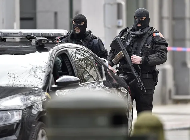 Special police secure the city center in Brussels, Belgium, Tuesday, March 22, 2016. Authorities locked down the Belgian capital on Tuesday after explosions rocked the Brussels airport and subway system, killing  a number of people and injuring many more. Belgium raised its terror alert to its highest level, diverting arriving planes and trains and ordering people to stay where they were. Airports across Europe tightened security. (Photo by Martin Meissner/AP Photo)