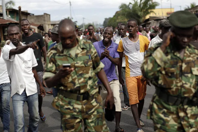 Protesters opposed to President Pierre Nkurunziza's decision to seek a third term in office shout at the army after a demonstrator was shot dead in the Kinama district of Bujumbura, Burundi, Thursday May 7, 2015. (Photo by Jerome Delay/AP Photo)