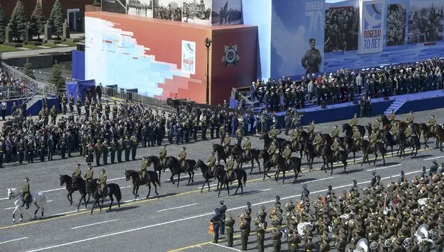 Russian servicemen in historical Red Army uniforms ride horses during the Victory Day parade at Red Square in Moscow, Russia, May 9, 2015. (Photo by Reuters/Host Photo Agency/RIA Novosti)