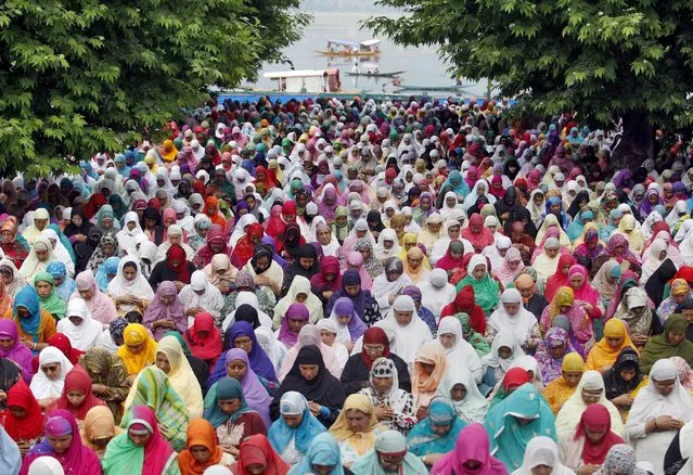 Kashmiri Muslim women offer prayers during Friday following celebrations for “Meeraj-un-Nabi” at the Hazratbal shrine in Srinagar May 22, 2015. Thousands of Kashmiri Muslims on Friday thronged the Hazratbal shrine, which houses what is believed to be a relic from the beard of Prophet Mohammed, to celebrate concluding ceremonies of Meeraj-un-Nabi or ascension of Prophet Mohammed to Heaven. (Photo by Danish Ismail/Reuters)