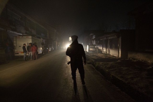 An Indian soldier guards near the site of an attack on the outskirts of Srinagar, Indian controlled Kashmir, Monday, December 13, 2021. Many policemen were injured in an attack which police blamed on rebels fighting against Indian rule. (Photo by Mukhtar Khan/AP Photo)
