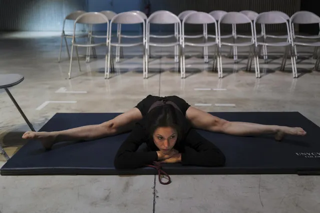 Performer Alice Rende from Brazil stretches prior to performing “Passages”, a contortionism creation in a space delimited by a Plexiglas box during the BIAC, International Circus Arts Biennale, in Marseille, south of France, Thursday, February 4, 2021. (Photo by Francois Mori/AP Photo)