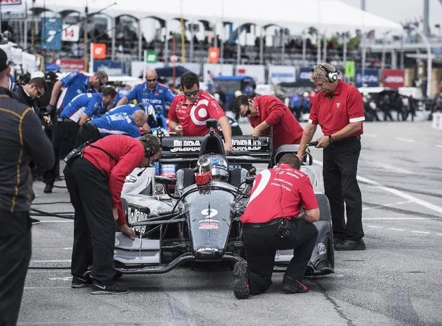 Scott Dixon hits the pits at practice for the IndyCar auto race Saturday, June 13, 2015, in Toronto. (Aaron Vincent Elkaim/The Canadian Press via AP)