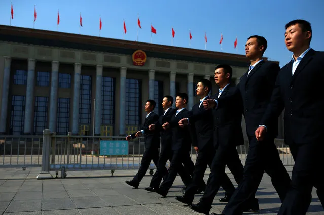 Security personnel walk past the Great Hall of the People before the opening session of the Chinese People's Political Consultative Conference (CPPCC) in Beijing, China, March 3, 2017. (Photo by Thomas Peter/Reuters)