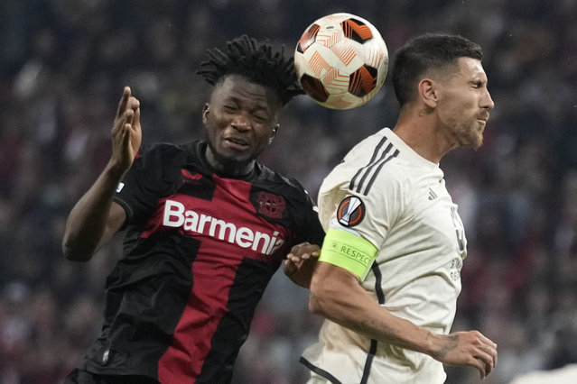 Leverkusen's Edmond Tapsoba, left, and Roma's Lorenzo Pellegrini jump for the ball during the Europa League second leg semi-final soccer match between Leverkusen and Roma at the BayArena in Leverkusen, Germany, Thursday, May 9, 2024. (Photo by Matthias Schrader/AP Photo)