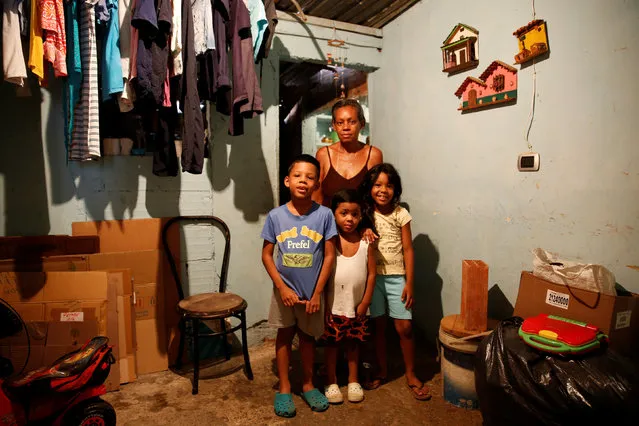 Rosa Elaisa Landaez (Back) poses for a picture next to her relatives (L-R) Albert Perez, Abel Perez and Yeiderlin Gomez at their home in Caracas, Venezuela April 23, 2016. “We are eating badly. For example, if we have corn flour, we eat arepas all day. If you have the money you can't find the foods and if you find you them you do not have enough money”, Landaez said. (Photo by Carlos Garcia Rawlins/Reuters)