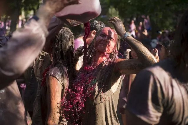 A young woman is drenched in wine during the Batalla de Vino (Wine Battle) in Haro, northern Spain June 29, 2015. (Photo by Vincent West/Reuters)