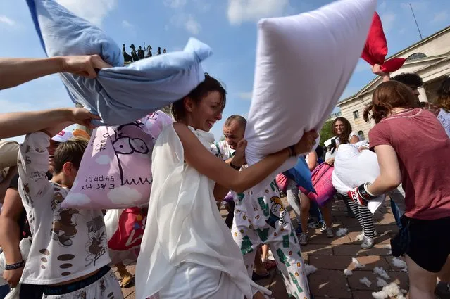 People take part in a “pillow fight” at the Arco della Pace on April 12, 2014 in Milan. (Photo by Giuseppe Cacace/AFP Photo)