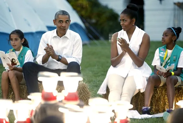U.S. President Barack Obama makes a silly face as he and first lady Michelle Obama sing with Girl Scouts during a camp out on the South Lawn of the White House in Washington June 30, 2015. A group of 50 fourth-grade Girl Scouts plans to spend the night in camping tents on the lawn, a celebration of the scouting movement and the National Park Service centennial. (Photo by Jonathan Ernst/Reuters)