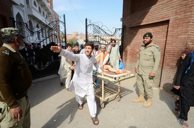 People move an injured on a stretcher after a bomb blast in a mosque during Friday prayers, at a hospital in Peshawar, Pakistan, March 4, 2022. (Photo by Khuram Parvez/Reuters)