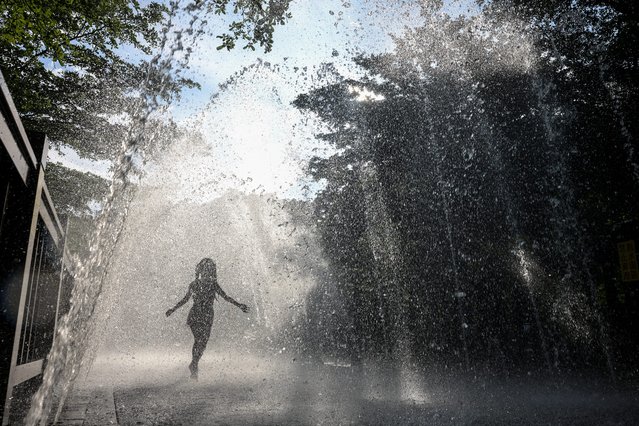 A child plays at a local water park amid an orange heat advisory in Keelung on July 2, 2024. (Photo by I-Hwa Cheng/AFP Photo)