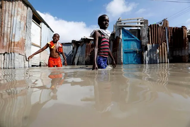 Somali children wade through flood waters after heavy rain in Mogadishu, Somalia on October 21, 2019. (Photo by Feisal Omar/Reuters)