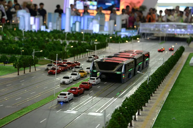 A model of a street-straddling bus that drives over cars is seen presented at an exhibition in Beijing, China, May 20, 2016. Part subway, part bus, a mass transporter known in Chinese as the “bus-way” went on show in Beijing. (Photo by Hu Qingming/Reuters)