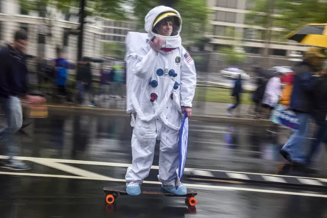 Max Gold, 20, of NYC, cruises on his skateboard as thousands gather on the National Mall for the March for Science on Saturday, April 22, 2017, in Washington, DC.  Activists and scientists descend on the nation's capital to rally for environmental causes and government policies rooted in scientific research as part of the Earth Day and March for Science rallies. (Photo by Jahi Chikwendiu/The Washington Post)