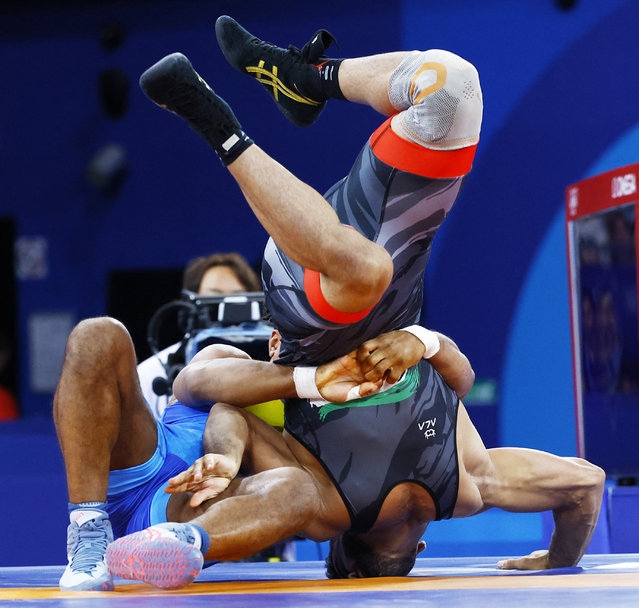 Zhan Beleniuk of Ukraine and Alireza Mohmadipiani of Iran compete during their men's Greco-Roman 87kg semi-final wrestling match at the Paris 2024 Olympics at Champ-de-Mars Arena in Paris, France on August 7, 2024. (Photo by Kim Kyung-Hoon/Reuters)