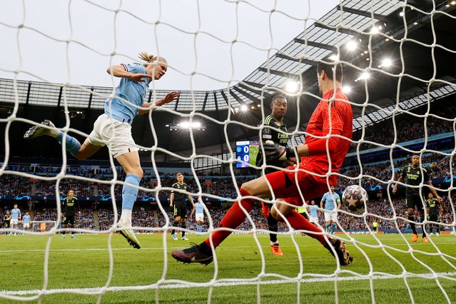 Thibaut Courtois and David Alaba of Real Madrid clear the ball from Erling Haaland of Manchester City during the UEFA Champions League semi-final second leg match between Manchester City FC and Real Madrid at Etihad Stadium on May 17, 2023 in Manchester, England. (Photo by Clive Brunskill/Getty Images)