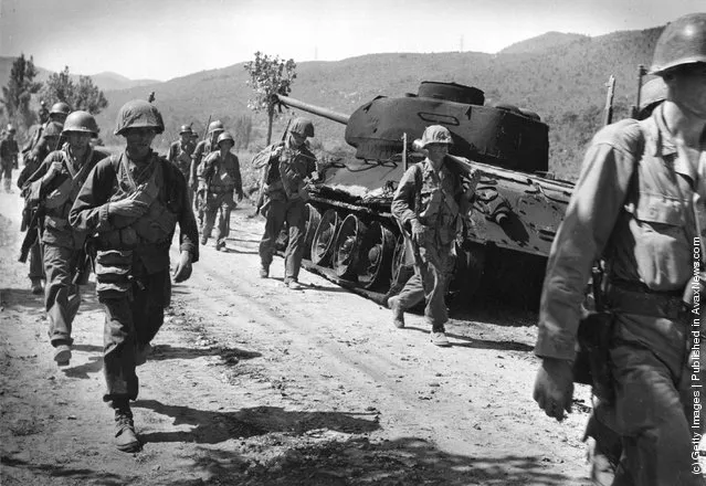 American troops walking down a road in Korea