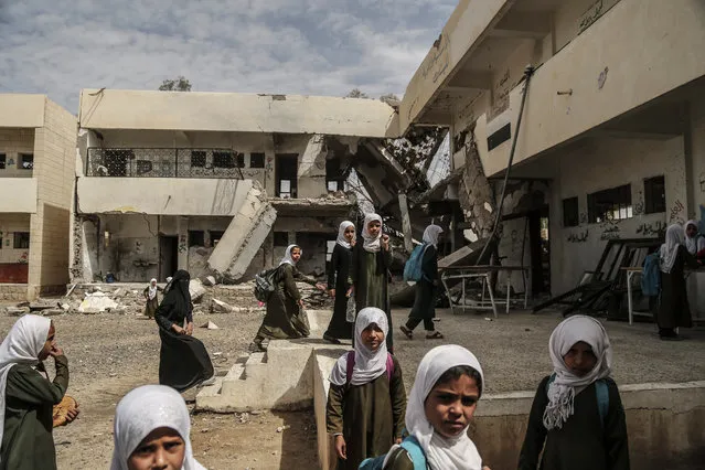 A picture made available on 03 June 2016 showing Students of al-Munadhil school for girls walk at the school court during a break, the school has been bombed by the Saudi Arabia-led coalition during raids in Saada city, Yemen, 18 April 2016. The northern city has been extensively bombed as the entire Saada Governorate was declared a military target. (Photo by Asmaa Waguih/EPA)