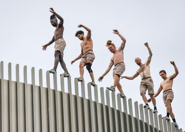 Artists from Lézards Bleus perform parkour during the Greenwich+Docklands international festival in London, England on August 31, 2024. (Photo by Imageplotter/Alamy Live News)