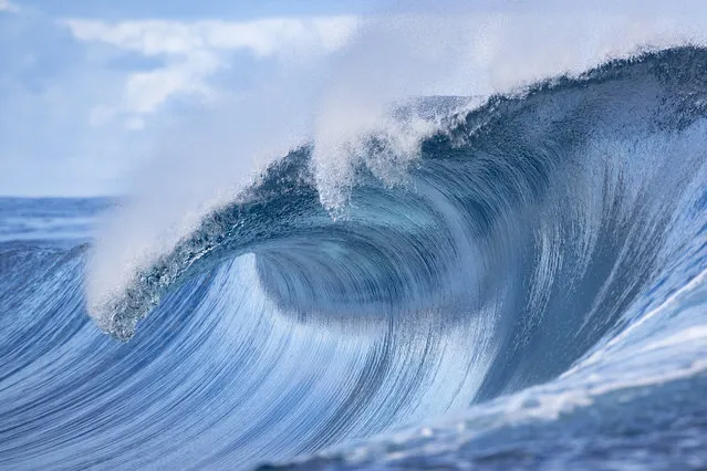 A wave crashes off Teahupoo, Tahiti, on August 28, 2019. (Photo by Brian Bielmann/AFP Photo)