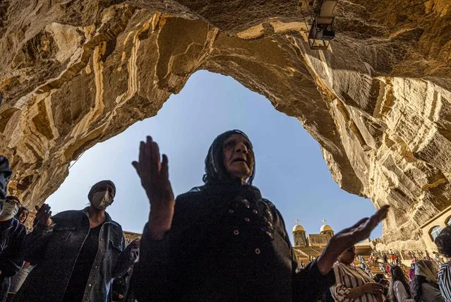 Coptic Orthodox Christians observe Good Friday prayers at the Saint Simon Monastery, also known as the Cave Church, in the Mokattam mountain of Egypt's capital Cairo on April 22, 2022. (Photo by Khaled Desouki/AFP Photo)