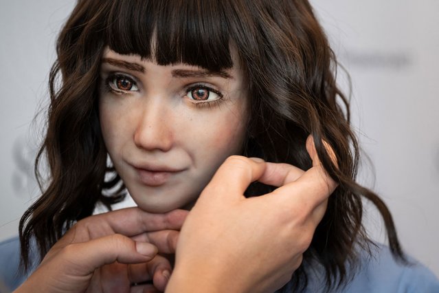 A staff sets the wig of healthcare assistant robot “Grace” at the booth of SingularityNET company during the world's largest gathering of humanoid AI Robots as part of International Telecommunication Union (ITU) AI for Good Global Summit in Geneva, on July 5, 2023. The United Nations is convening this week a global gathering to try to map out the frontiers of artificial intelligence and to harness its potential for empowering humanity, hoping to lay out a clear blueprint on the way forward for handling AI, as development of the technology races ahead the capacity to set its boundaries. (Photo by Fabrice Coffrini/AFP Photo)