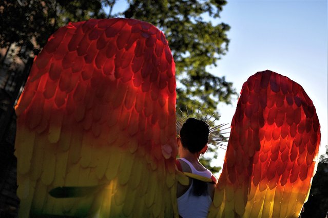 A participant with rainbow-colored wings attends the parade of the LGBTIQ+ (lesbian, gay, bisexual, transgender, intersex and queer) Pride parade in Barcelona on July 15, 2023. (Photo by Pau Barrena/AFP Photo)