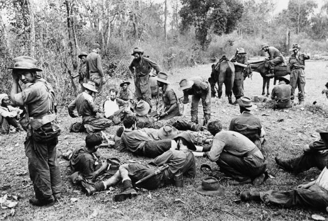 Members of Col. Philip Cochran's first air commandos, some of them nursing battle wounds, relax at the edge of a landing strip deep in the interior of Burma, June 3, 1944 where they are pressing forward their attacks against the Japanese. (Photo by AP Photo)