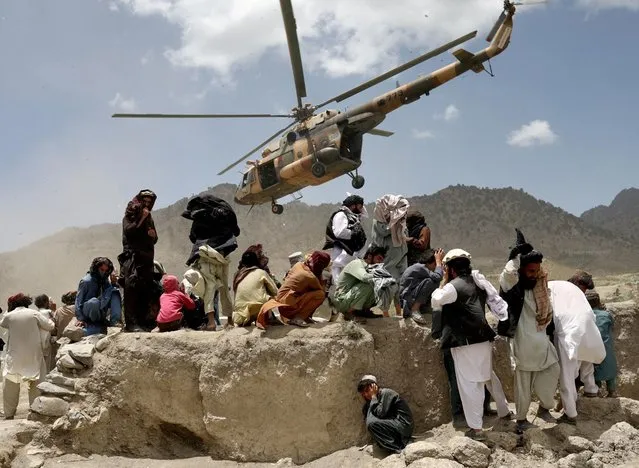 A Taliban helicopter takes off after bringing aid to the site of an earthquake in Gayan, Afghanistan on June 23, 2022. (Photo by Ali Khara/Reuters)