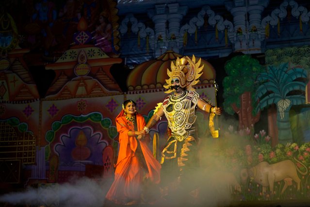 Vikas Sirswal, 32, right, playing the character of the demon king Ravana and Hitanshi Jha, 21, playing the character of Sita perform onstage during Ramleela, a dramatic folk re-enactment of the life of Hindu god Rama according to the ancient Hindu epic Ramayana, in New Delhi, India, Wednesday, October 9, 2024. (Photo by Manish Swarup/AP Photo)