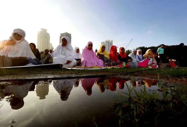 Muslims gather at a local park to mark the end of the holy month of Ramadan, known as Eid al Fitr, Wednesday, July 6, 2016 in Manila, Philippines. The Eid, one of the most important important holidays in the Muslim world, is marked with prayers, picnics and family reunions. (Photo by Bullit Marquez/AP Photo)