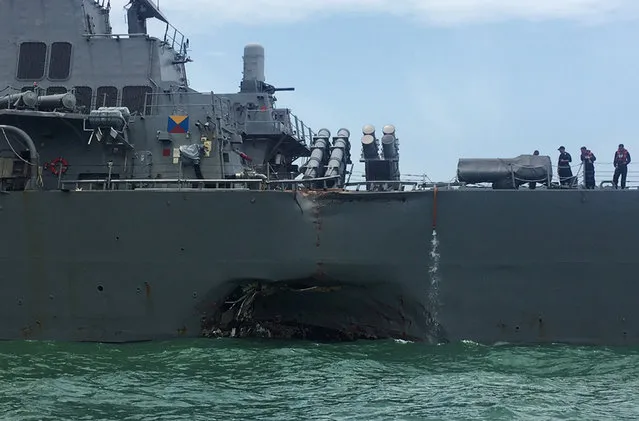 The U.S. Navy guided-missile destroyer USS John S. McCain is seen after a collision, in Singapore waters August 21, 2017. (Photo by Ahmad Masood/Reuters)