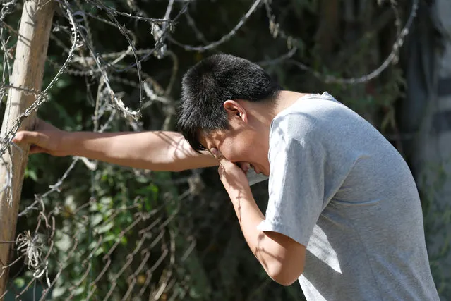 An Afghan boy mourns at the site of a suicide attack followed by a clash between Afghan forces and insurgents after an attack on a Shi'ite Muslim mosque in Kabul, Afghanistan on Friday, August 25, 2017. (Photo by Mohammad Ismail/Reuters)