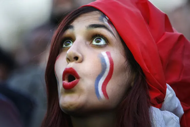 A French supporter watches the Euro 2016 semifinal soccer match between Germany and France,Thursday, July 7, 2016 in the  Paris fan zone. (Photo by Kamil Zihnioglu/AP Photo)
