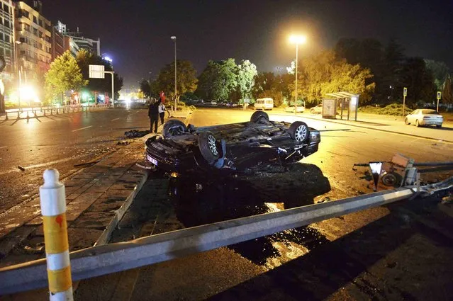 A flipped car lies in a road near military headquarters in Ankara, Turkey July 16, 2016. (Photo by Reuters/Stringer)