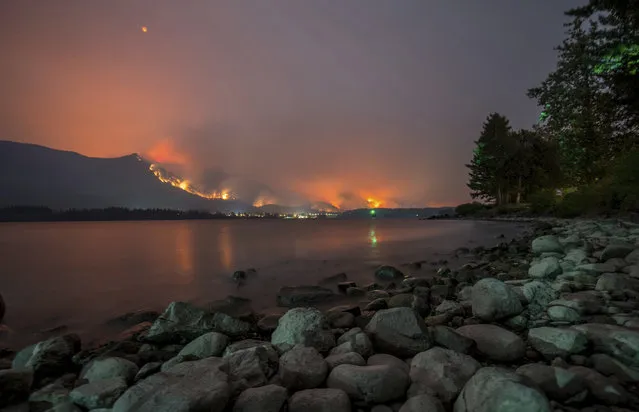 This Monday, September 4, 2017, photo provided by KATU-TV shows a wildfire as seen from near Stevenson Wash., across the Columbia River, burning in the Columbia River Gorge above Cascade Locks, Ore. A lengthy stretch of highway Interstate 84 remains closed Tuesday, Sept. 5, as crews battle the growing wildfire that has also caused evacuations and sparked blazes across the Columbia River in Washington state. (Photo by Tristan Fortsch/KATU-TV via AP Photo)