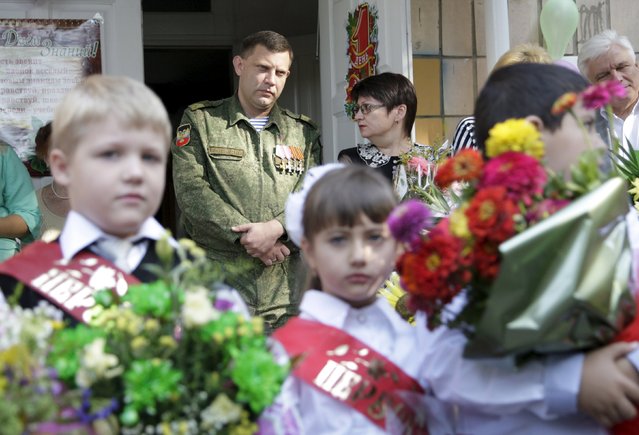Self-appointed head of the self-proclaimed Donetsk People's Republic Alexander Zakharchenko (back L) attends a ceremony to mark the start of another school year in Donetsk, Ukraine, September 1, 2015. (Photo by Alexander Ermochenko/Reuters)