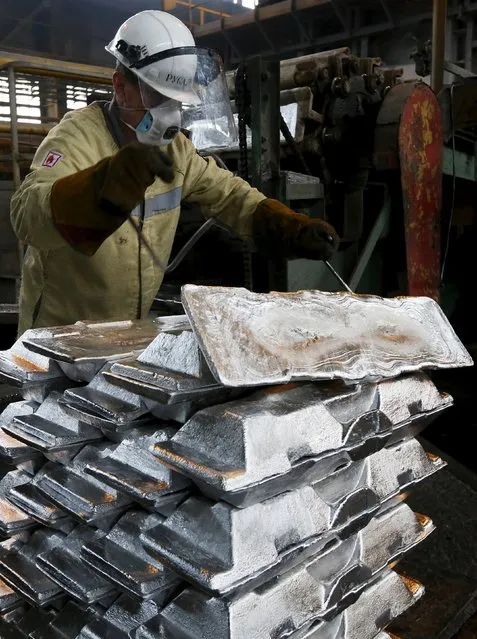 A worker stacks aluminium ingots at the foundry shop of the Rusal Sayanogorsk aluminium smelter outside the town of Sayanogorsk, Russia, September 3, 2015. (Photo by Ilya Naymushin/Reuters)