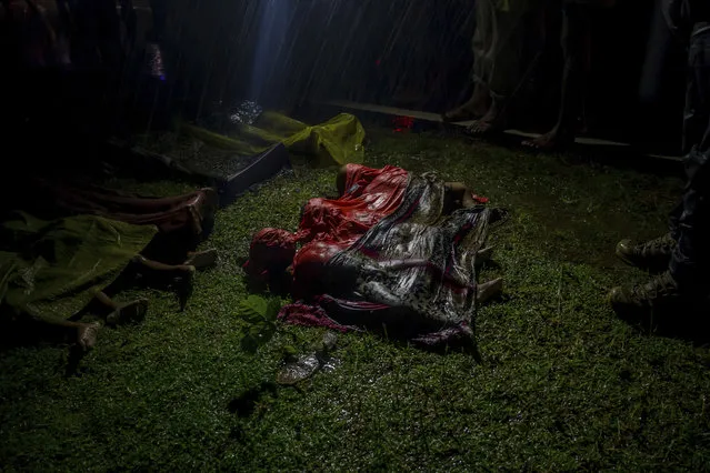 Bodies of Rohingya Muslim children, who died after their boat capsized in the Bay of Bengal as they were crossing over from Myanmar into Bangladesh, lies on a roadside near Inani beach, in Cox's Bazar district, Bangladesh, Thursday, September 28, 2017. (Photo by Dar Yasin/AP Photo)