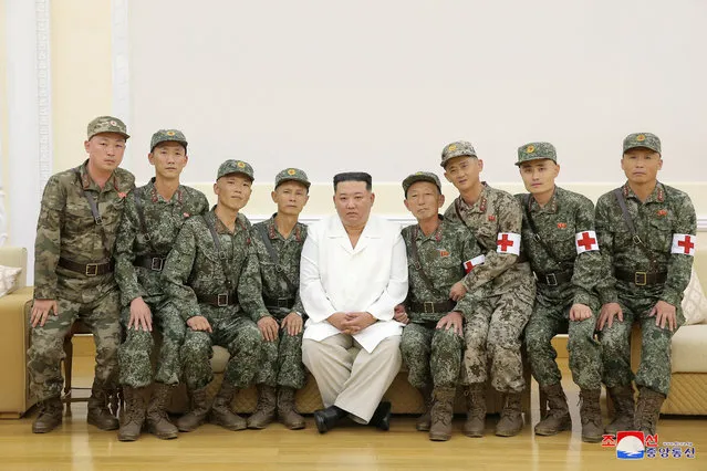 North Korea's leader Kim Jong Un poses for a photo with  Korean People's Army medics during a meeting to recognise their contributions in fighting the coronavirus disease (COVID-19) pandemic in Pyongyang, North Korea, August 18, 2022 in this photo released by North Korea's Korean Central News Agency (KCNA). (Photo by KCNA via Reuters)